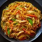Delicious Chicken Lo Mein with vegetables and noodles in a takeout container