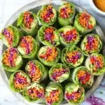 Fresh spring rolls served with creamy peanut sauce on a plate