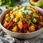 Loaded Potato Taco Bowl topped with fresh ingredients and flavorsome sauce