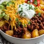 Loaded Potato Taco Bowl filled with crispy potatoes, toppings, and salsa.