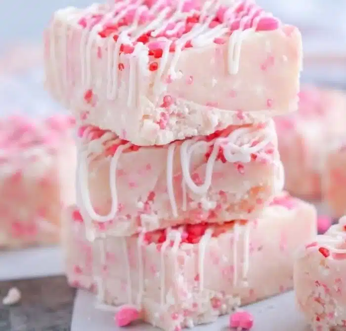 Delicious Valentine's Day sugar cookie fudge sprinkled with colorful sprinkles.