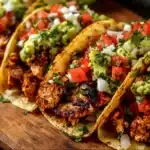 Plate of flavorful Chicken Street Tacos garnished with fresh ingredients