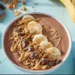 Delicious Chocolate Peanut Butter Smoothie Bowl topped with fruits and nuts