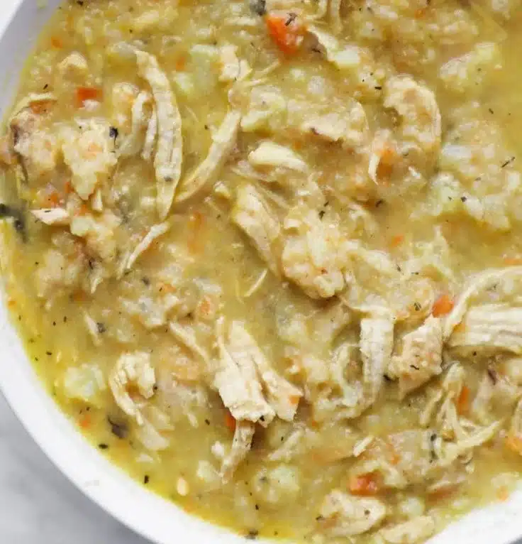 Bowl of 30-minute anti-inflammatory cauliflower chicken soup with fresh herbs.