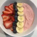 5-minute strawberry banana smoothie bowl topped with fresh fruit and granola