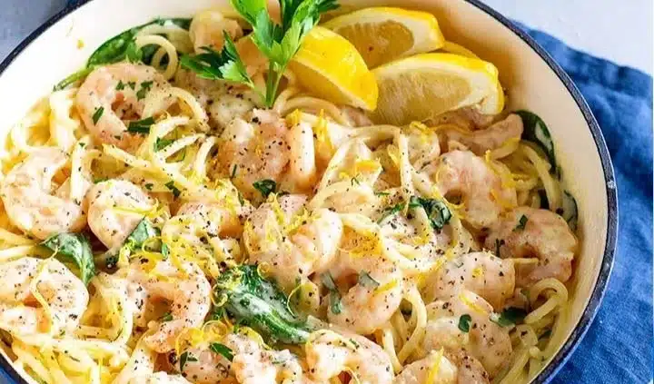 Creamy lemon shrimp pasta garnished with fresh herbs