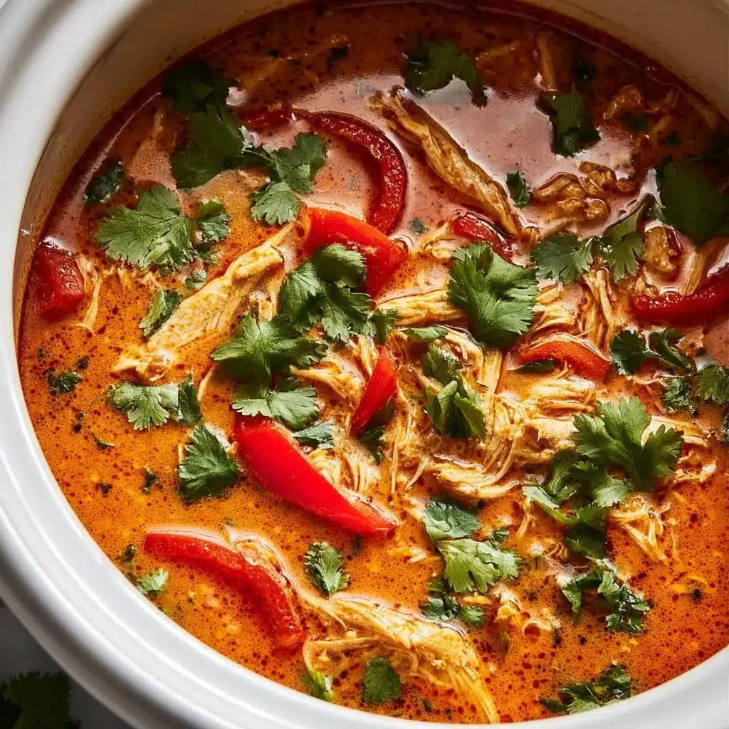 Bowl of Crockpot Thai Coconut Chicken Soup garnished with fresh herbs