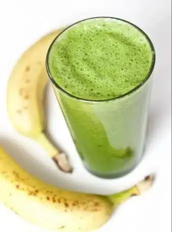 Refreshing fat burning green smoothie with fresh ingredients in a glass