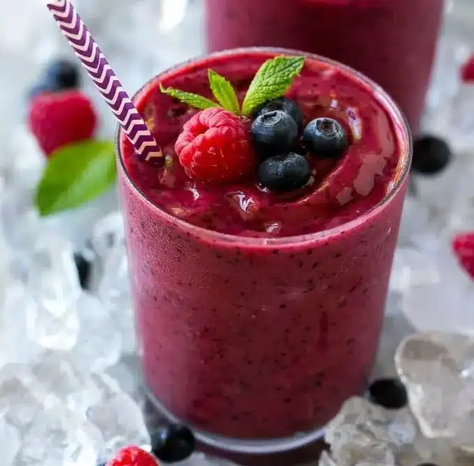Delicious frozen fruit smoothie with mixed berries and banana in a glass