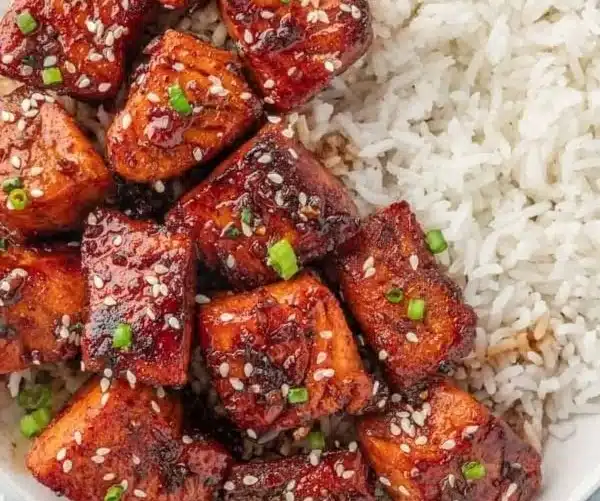 Plate of honey glazed salmon bites with garnishes