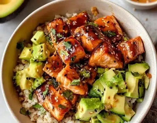 Delicious honey glazed salmon bowl with vibrant vegetables and rice