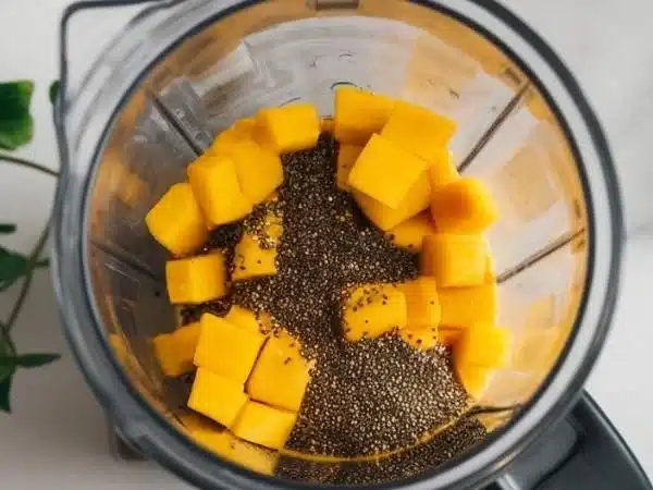 Delicious Mango Chia Seed Smoothie in a glass with fresh ingredients.