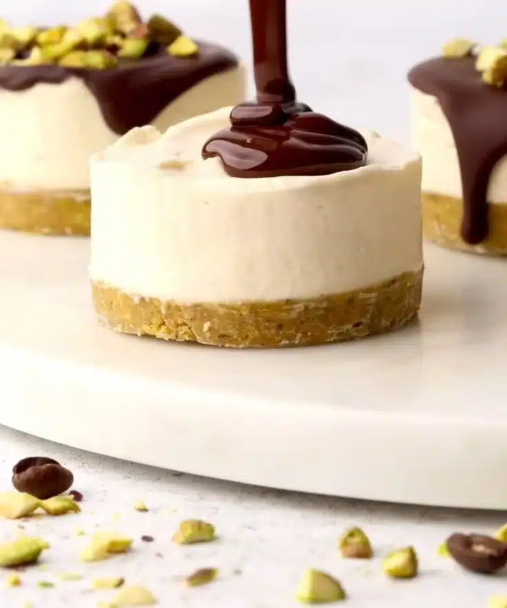 Mini pistachio and coffee cheesecakes served on a platter