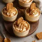 No-bake Biscoff cheesecake cups topped with whipped cream and Biscoff crumbs.