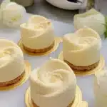 Delicious Pecan Vanilla Dessert topped with nuts and creamy vanilla sauce