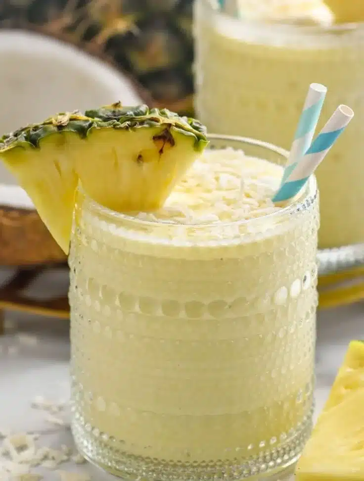 Refreshing Pina Colada smoothie in a glass with tropical fruit garnish