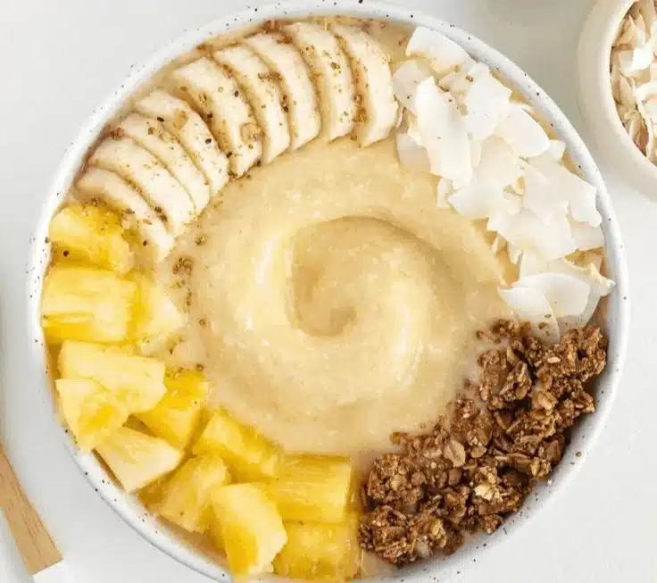 Delicious Pineapple Coconut Smoothie Bowl topped with fresh fruits and coconut flakes