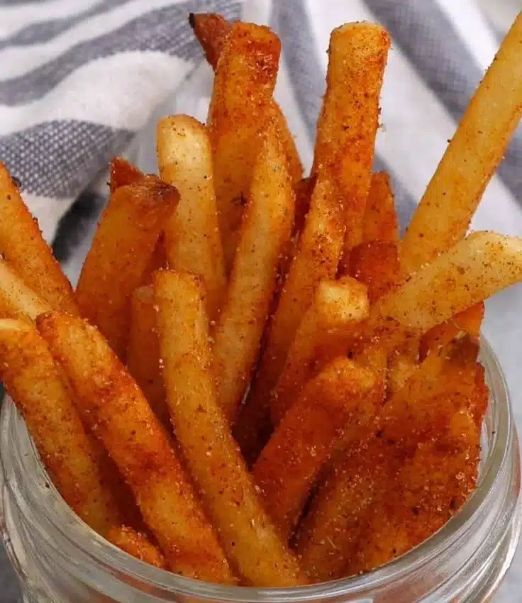 Delicious copycat Popeyes Cajun fries recipe served hot and crispy.