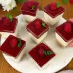 Raspberry Cheesecake in a Glass dessert with fresh raspberries and cream
