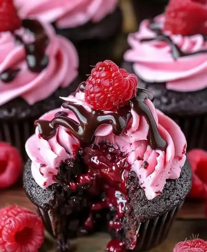 Raspberry Chocolate Lava Cupcakes with molten chocolate center and raspberry topping