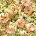 Sautéed lemon garlic butter shrimp pasta served in a bowl with parsley garnish