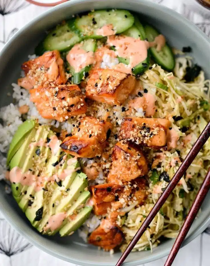 Delicious spicy salmon maki bowl garnished with fresh ingredients.