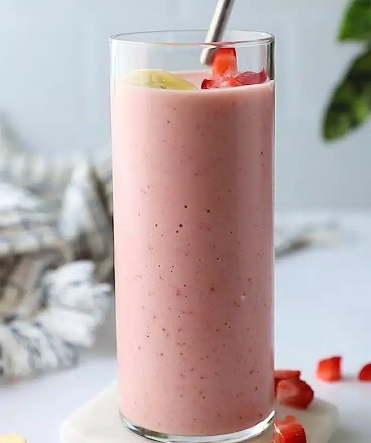 Refreshing strawberry banana smoothie in a glass with fresh fruit