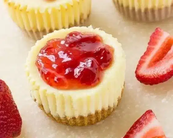 Delicious strawberry cheesecake bites topped with fresh strawberries and creamy filling
