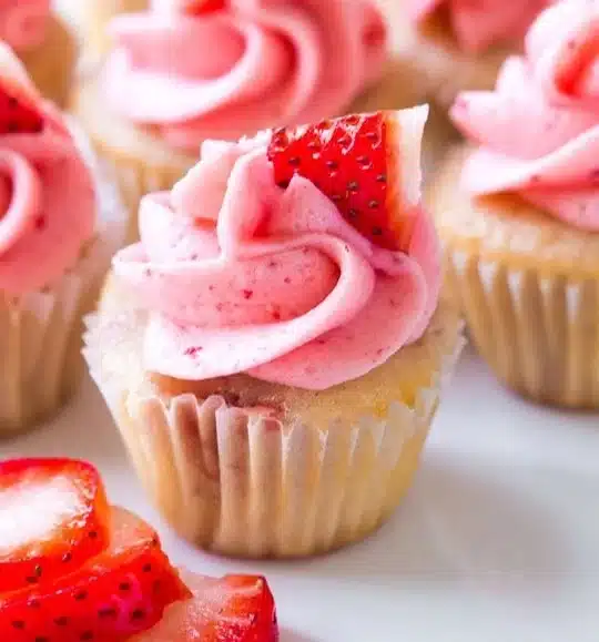 Delicious strawberry cupcakes topped with fresh strawberry frosting