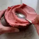 Thick strawberry pineapple smoothie bowl topped with fresh fruits