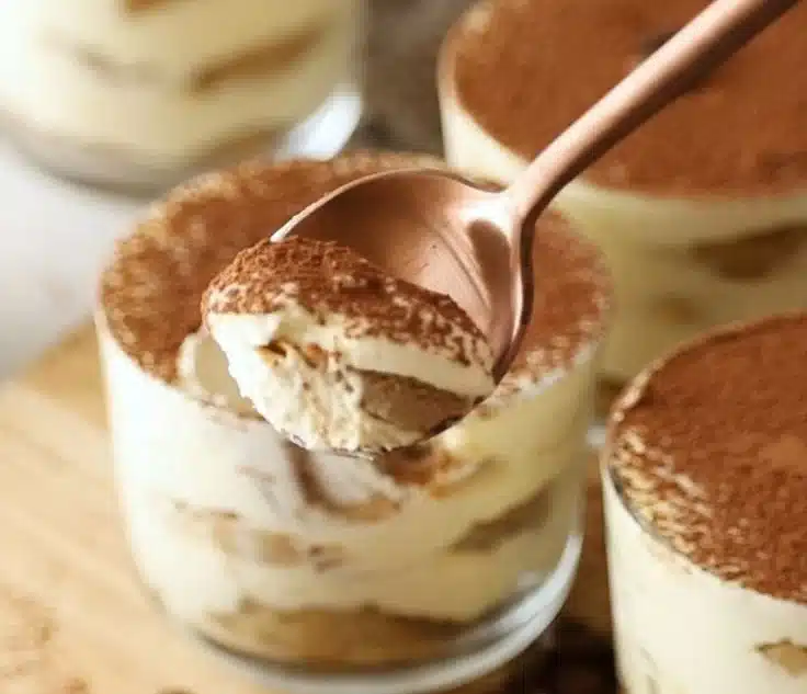 Delicious tiramisu cups topped with cocoa powder and chocolate shavings