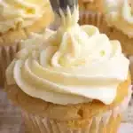 Delicious vanilla cupcakes topped with creamy frosting and sprinkles.
