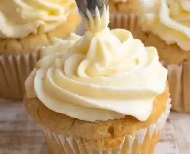 Delicious vanilla cupcakes topped with creamy frosting and sprinkles.