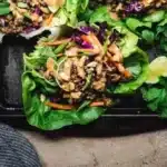 Vegan Asian lettuce wraps filled with veggies and served on crisp lettuce leaves