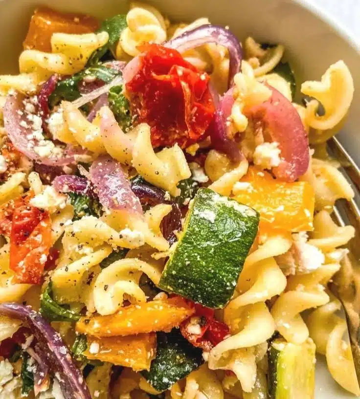 Baked Feta Pasta topped with fresh basil and cherry tomatoes