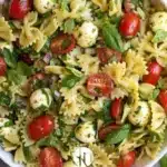 Colorful bow tie pasta salad with fresh vegetables and dressing