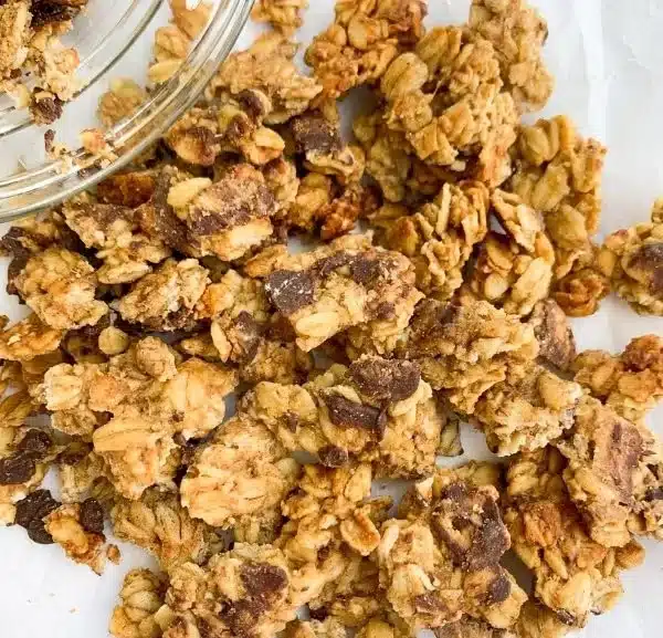 Bowl of Chunky Monkey Granola featuring oats, bananas, nuts, and chocolate.