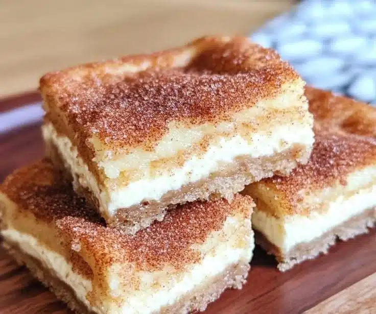 Delicious churro cheesecake bars topped with cinnamon and sugar