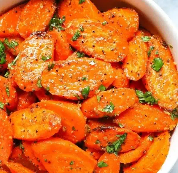 Bowl of easy ranch roasted carrots, seasoned and ready to serve.