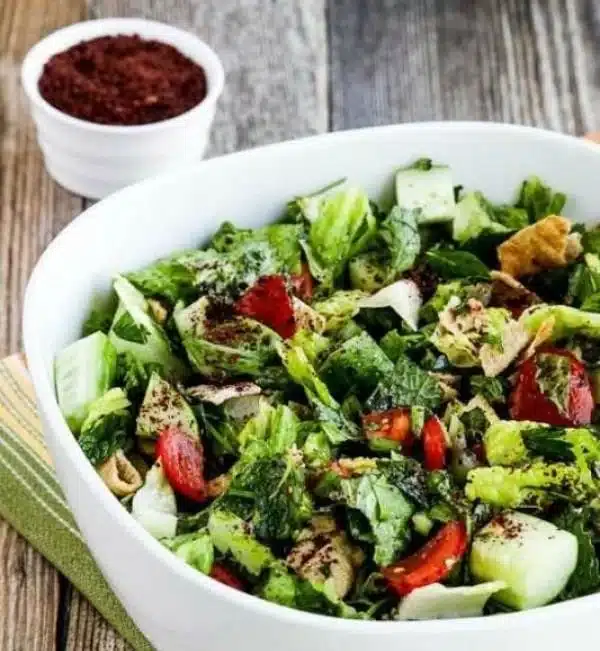 Fattoush Lebanese salad featuring fresh vegetables, sumac, and pita chips.