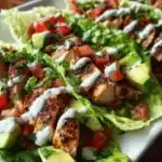 Grilled chicken avocado lettuce wraps served on a plate