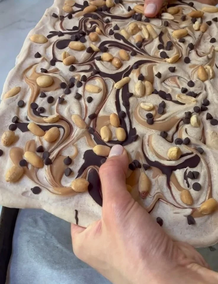 Peanut Butter Chocolate Frozen Yogurt Bark topped with chocolate and nuts.