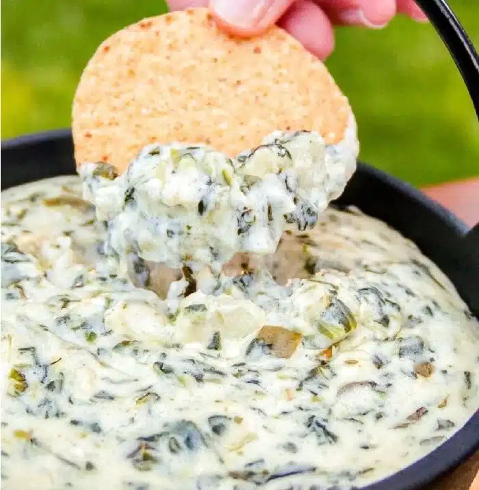 Delicious Spinach Artichoke Dip served in a bowl with tortilla chips