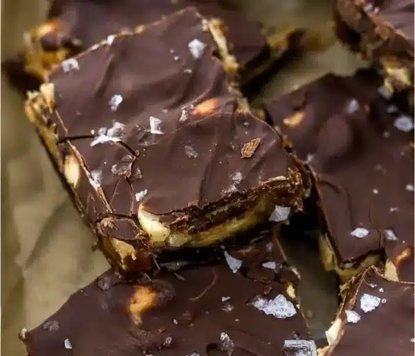 Delicious chocolate date bark with nuts and fruits on a white plate